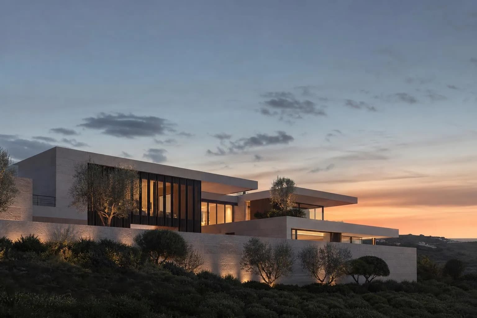 Modernist house facade at dusk with geometric forms and clean lines against twilight sky