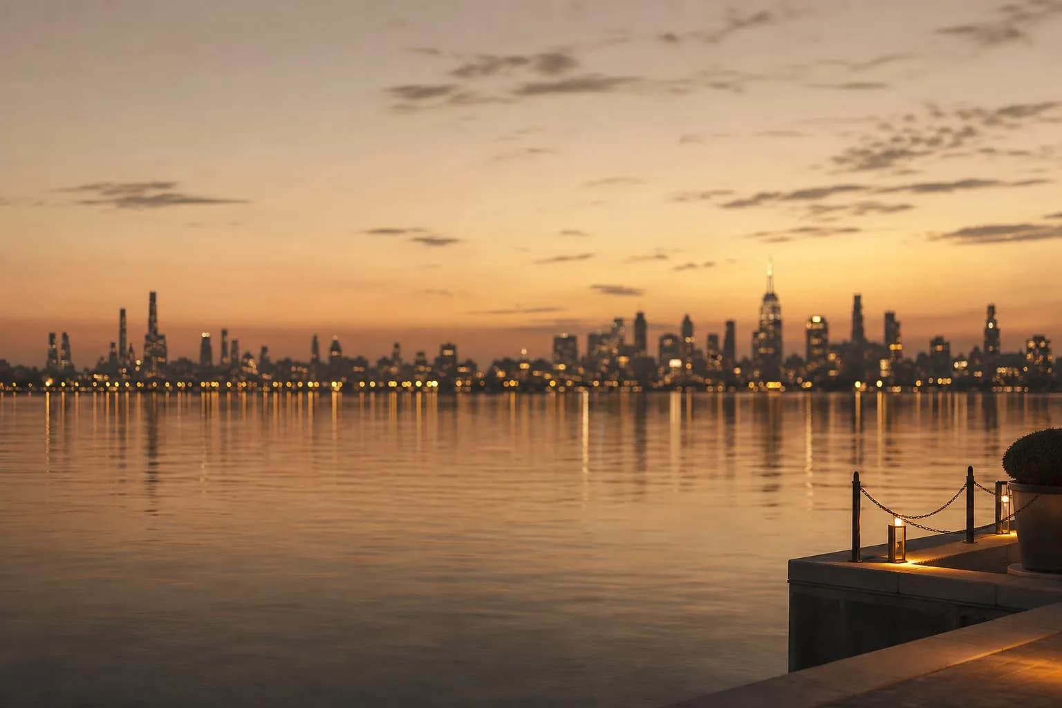 Distant city skyline glowing at dusk across still water, viewed from afar