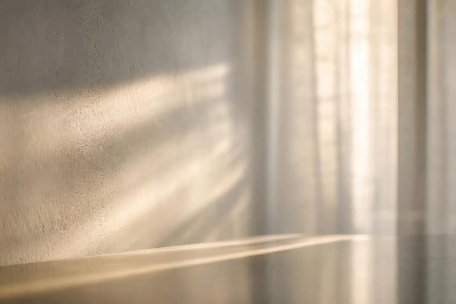 Minimalist abstract image of soft sunlight filtering through sheer curtains, casting gentle shadows