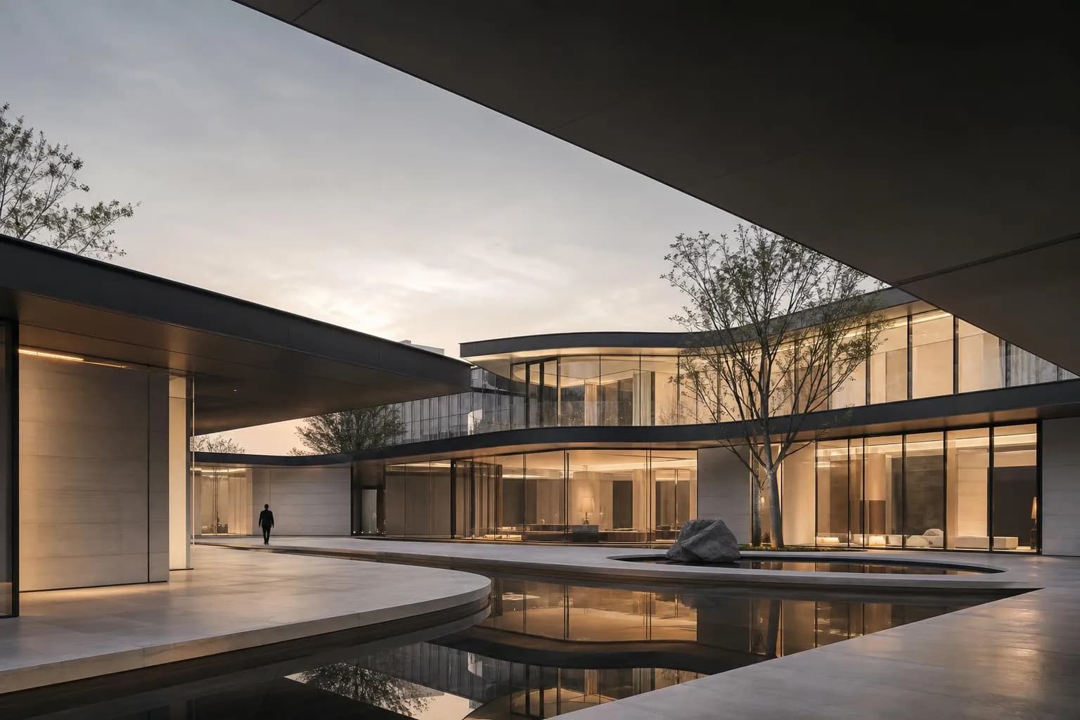 Modernist building with clean geometric lines and flowing interior courtyard in soft natural light.