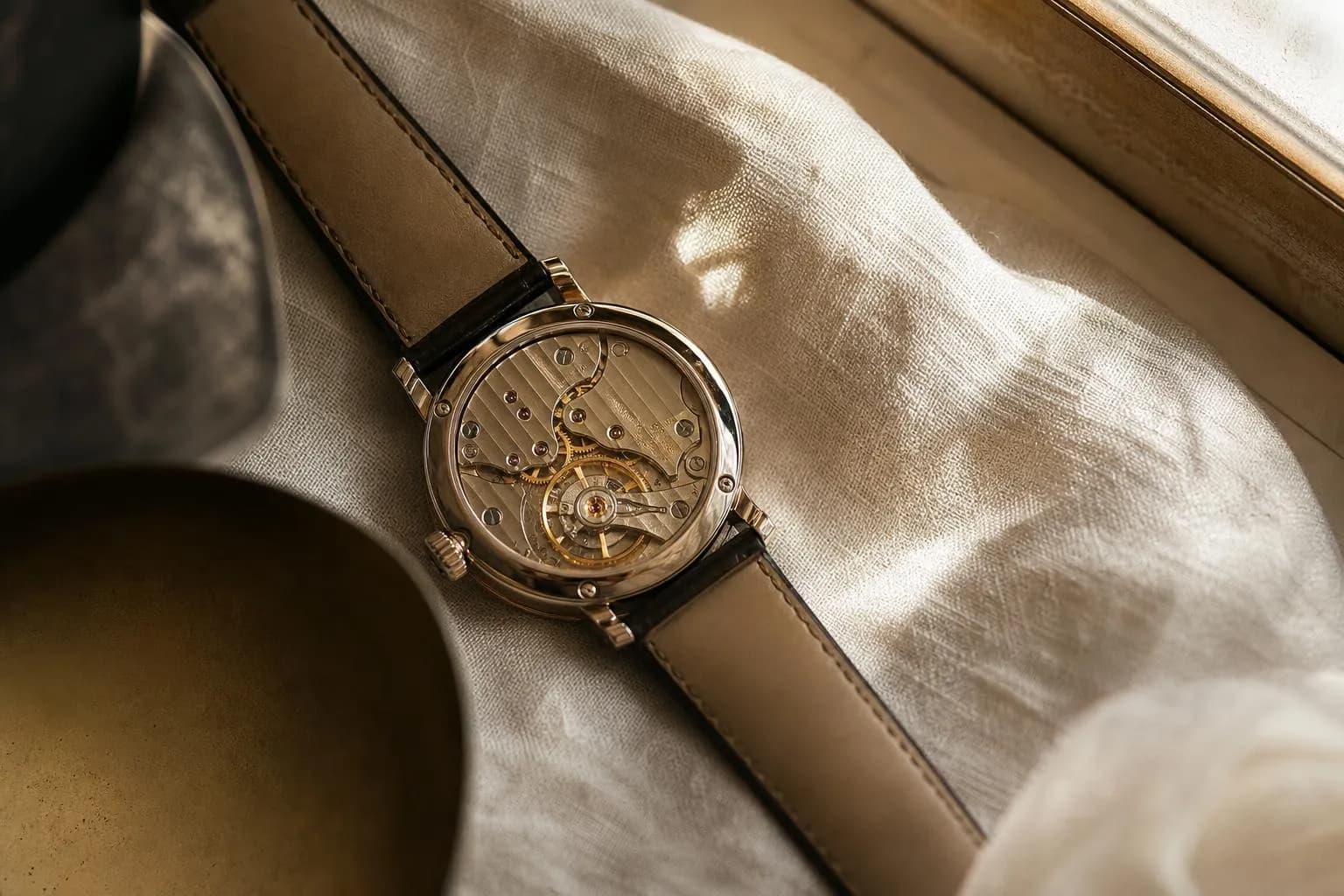 Luxury mechanical watch on cream linen, soft natural light, detailed craftsmanship.