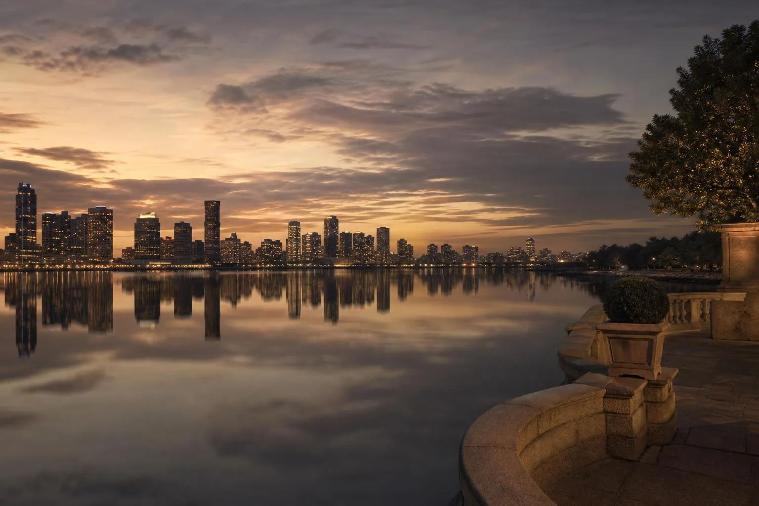 Distant city skyline glowing across calm water at dusk, reflective and serene.