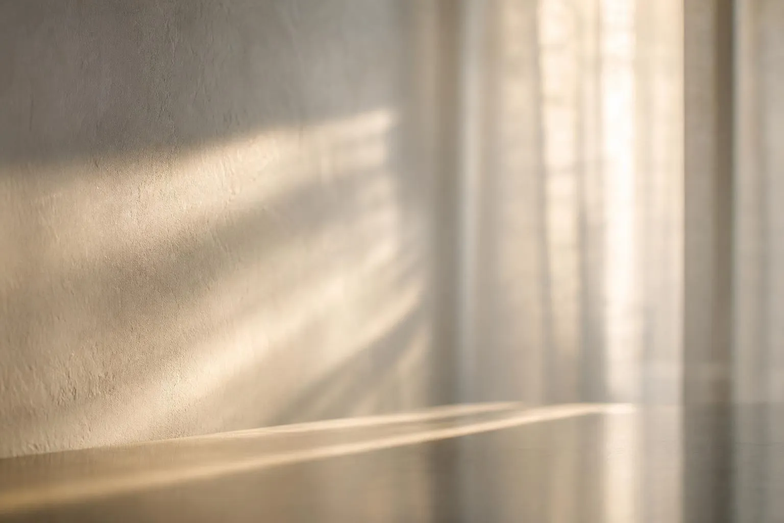 Minimalist abstract image of soft sunlight filtering through sheer curtains, casting gentle shadows