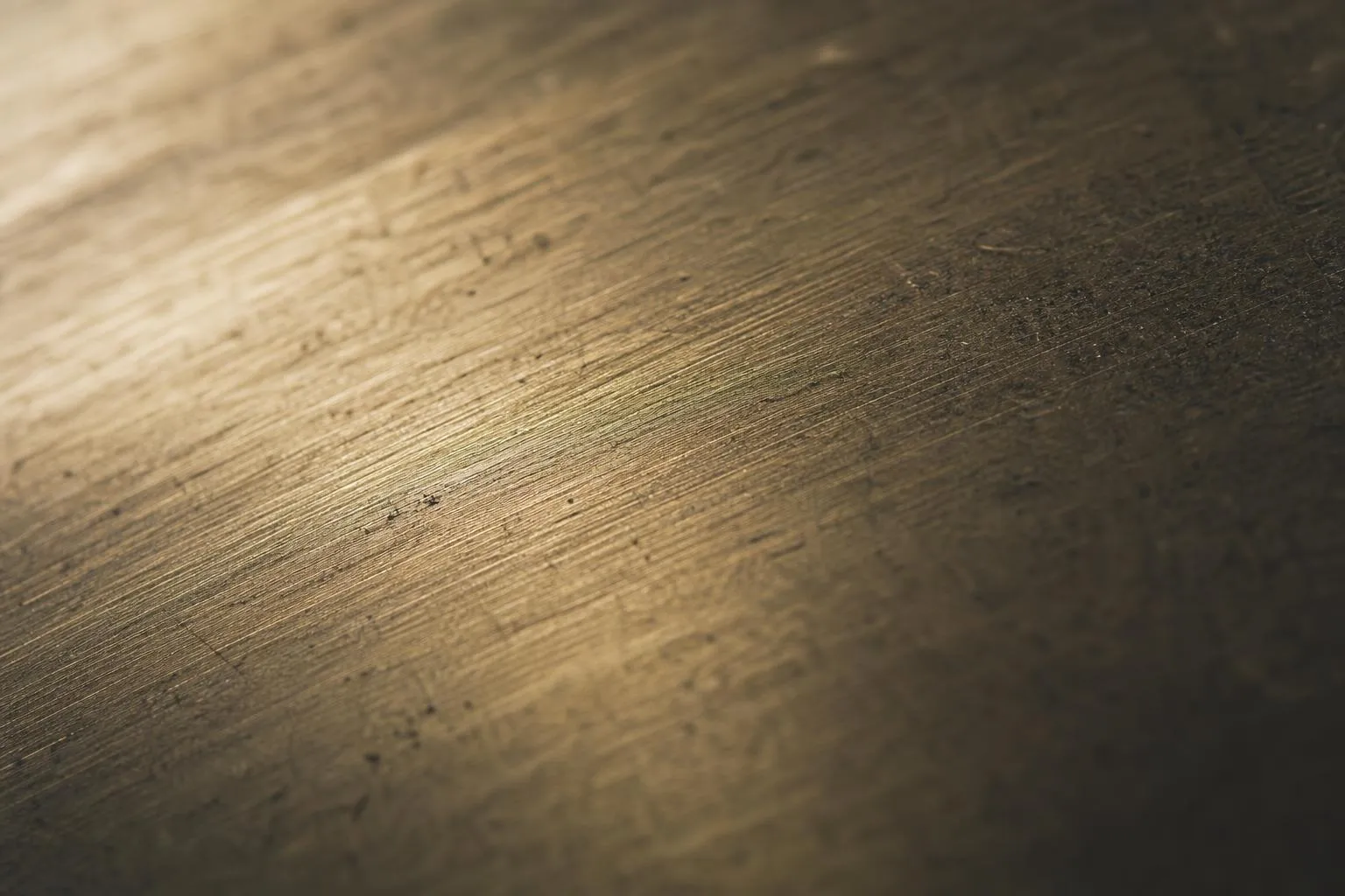 Close-up of brushed metal surface with subtle texture and patina