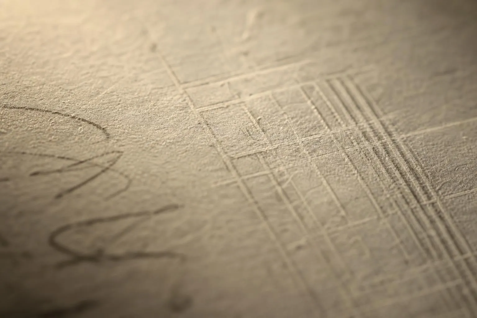 Close-up detail of aged paper texture with subtle markings and embossed surface.